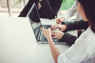 Businesspeople working  on the laptop while meeting  in the meeting room at the office.