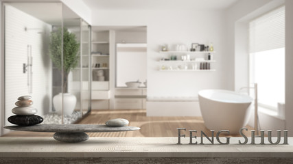 Wooden vintage table shelf with stone balance and 3d letters making the word feng shui over...