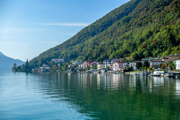 The view of the village of Melide on the shore of  the lake of Lugano on a warm sunny day in Autumn