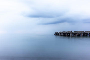 Obraz premium An abandoned pier on the Tuscan sea in Autumn at sunset with long exposure effect - 3
