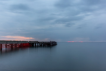 Fototapeta na wymiar An abandoned pier on the Tuscan sea in Autumn at sunset with long exposure effect - 8