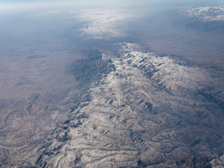 Aerial view of snow covered mountain ranges
