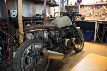 Fototapeta na wymiar Custom made motorcycle. Indoors of custom motorcycle workshop. Close up shoots of customized motorcycle.