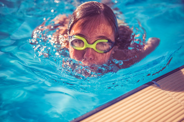 Naklejka premium Girl rising from swimming pool
