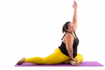 Studio shot of young happy fat Asian woman smiling while stretch