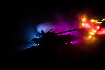 Obraz na płótnie Canvas War Concept. Military silhouettes fighting scene on war fog sky background, World War German Tanks Silhouettes Below Cloudy Skyline At night. Attack scene. Armored vehicles. Tanks battle