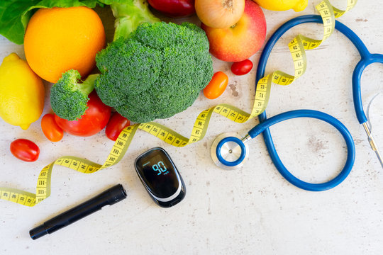 raw vegetables with blood glucose meter, lancet and stethoscope, , diabetes healthy diet concept