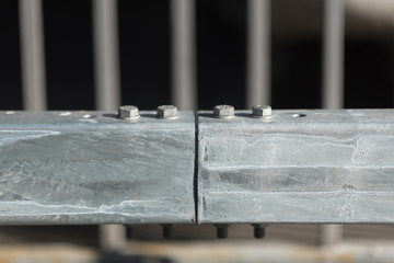 Anodized safety steel barrier on freeway bridge, close up