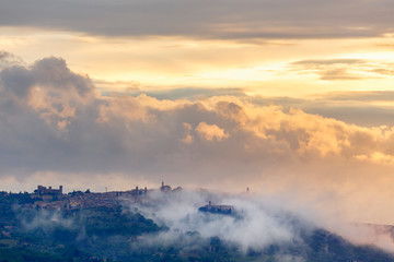 Fototapeta premium Mountain village with clouds at dusk