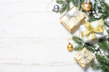 Christmas background with gold and silver decorations on white.