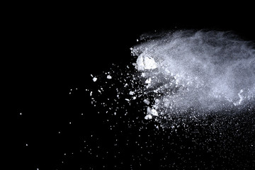 White powder explosion on black background. Dust splatted isolated. Paint Holi.