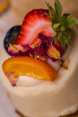 Cake with strawberries, raspberries, blueberries, close-up.
