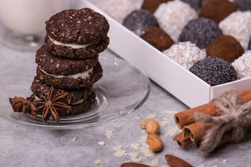 Brown biscuits close-up. Cookies with nuts on a bright table with nuts, cinnamon, milk