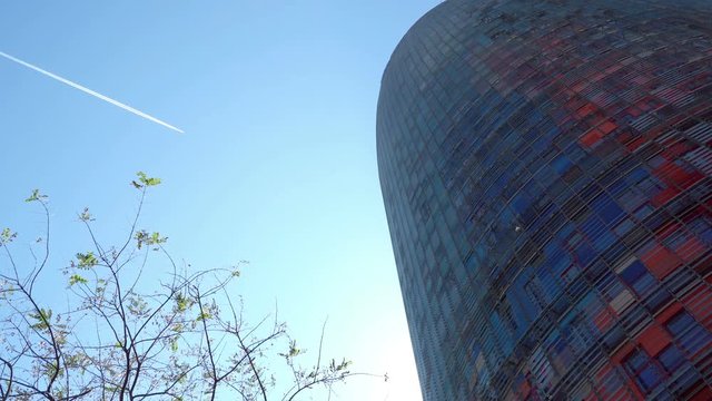 Aaiplane flying in the sky above the office building