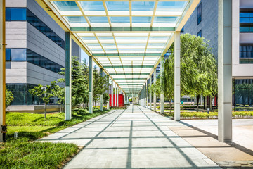 outdoor empty corridor with garden in the modern office building.