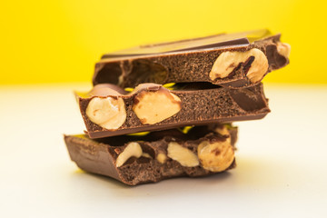 Chocolate pieces against yellow background