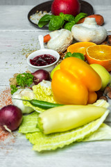 fresh vegetables, fruits, herbs nad spices on white wooden table