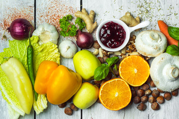fresh vegetables, fruits, herbs nad spices on white wooden table