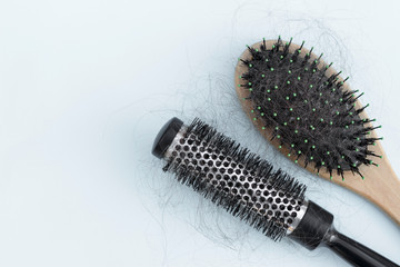 Two combs with loose hair, concept of hair loss, hair care