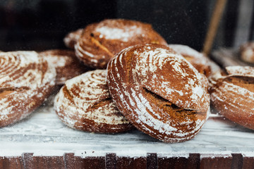 Freshly and warm baked bread rolls place on top marble counter for sell. Homemade by artisan.