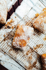 Freshly and warm baked bread rolls place on top marble counter for sell. Homemade by artisan.