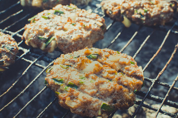 frying cutlets for burgers on the grill