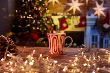 Christmas still life with mug and fireplace