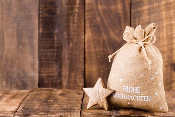 Christmas greeting card wooden background.