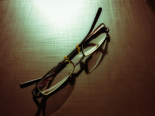 glasses on a dark background, shadow of the rim, metallic material