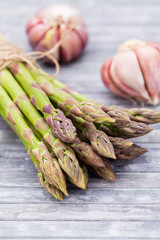 Bunch of fresh asparagus on wooden table.