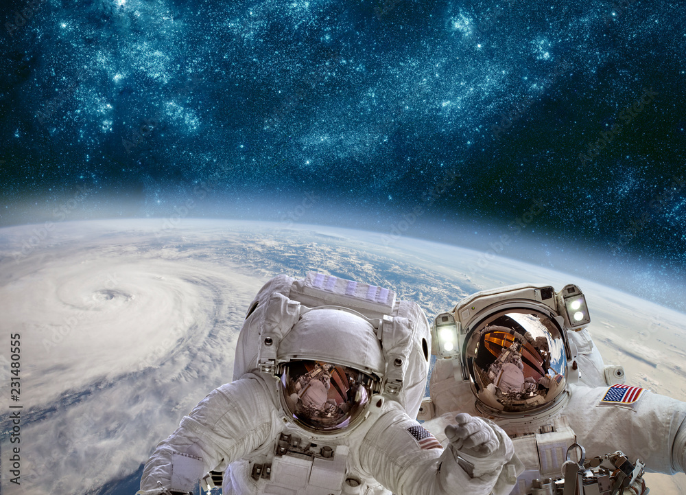 Wall mural astronaut in outer space against the backdrop of the planet earth. typhoon over planet earth.