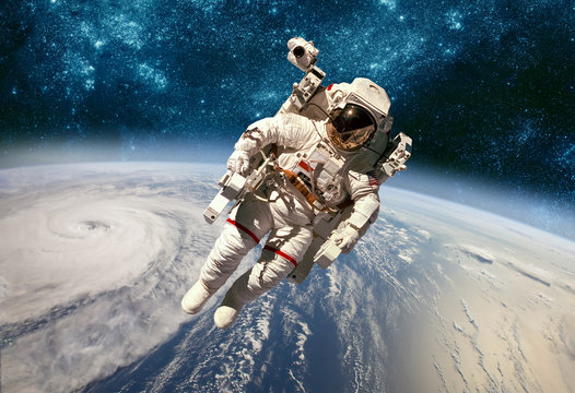 Fototapeta Astronaut in outer space against the backdrop of the planet earth. Typhoon over planet Earth.