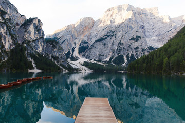 Beautiful landscape of Braies Lake (Lago di Braies), romantic place with wooden bridge and boats on the alpine lake, Alps Mountains, Dolomites, Italy, Europe