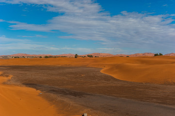 View from the dunes to the city Merzouga in Morocco, Africa