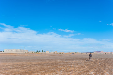 Fototapeta na wymiar Girl walk alone near Merzouga, Morocco