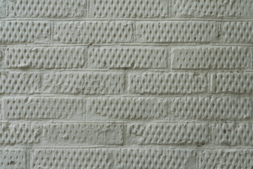 Brick wall painted in bright gray color. The texture of the brickwork.