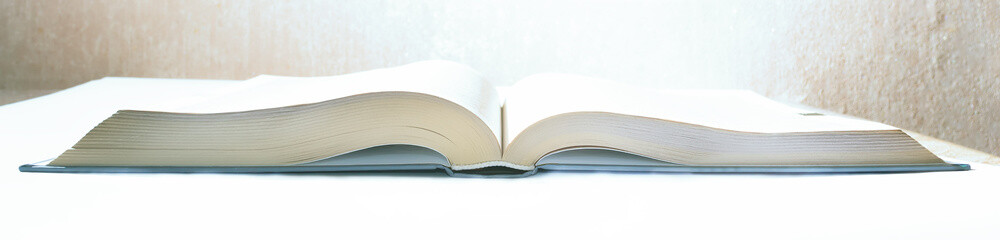 old book on white isolated background and on wall background with reflections and scuffs