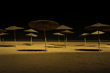 Sunshades on beach at night Essaouira, Morocco