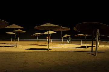 Sunshades on beach at night Essaouira, Morocco