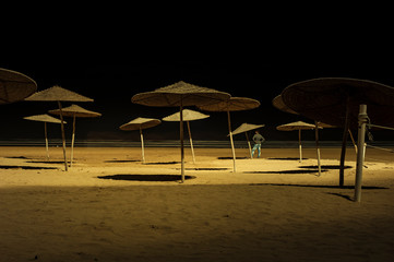 Sunshades on beach at night Essaouira, Morocco