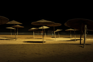 Sunshades on beach at night Essaouira, Morocco