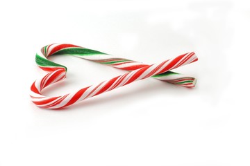 Christmas Candy cane with red and green Bow isolated on white background