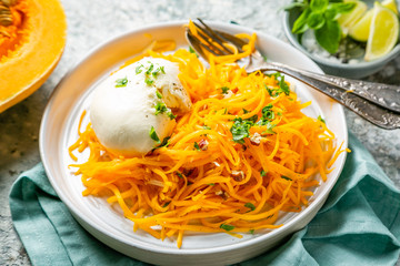 Butternut squash noodles with mozzarela, pecans, herbs, copy space