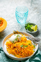 Butternut squash noodles with mozzarela, pecans, herbs, copy space