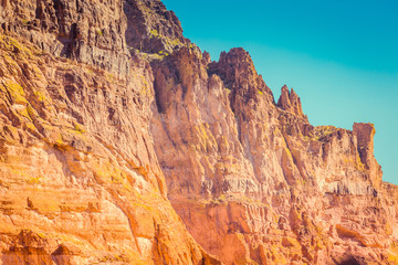 The sheer red and orange cliffs surround Canyon Lake in the wilderness desert east of Phoenix Arizona cliffs reach to the sky in this natural surrounding