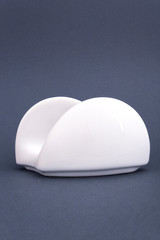 Ceramic white napkin stand on grey background. Mock up for design.