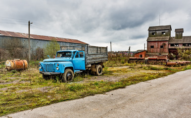 Old agricultural machinery, old truck. .Abandoned collective farm. Russia, Tula region.