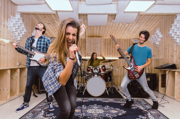 Rock music band performing on a recording studio