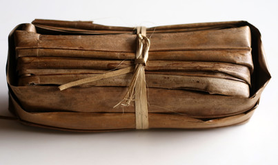 Traditional brown sugar or palm sugar from Ciamis, West Java, Indonesia. Wrapped in palm leaves.
