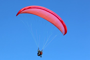 Tandem paraglider flying